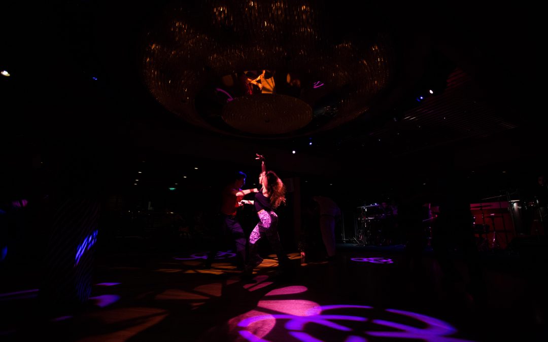 A couple dances to salsa music in the ballroom of a Royal Caribbean cruise ship. Almudena Toral/Univision